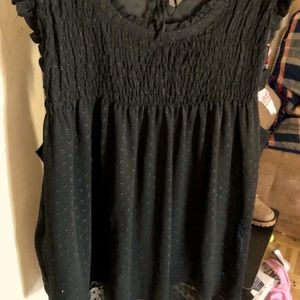 Black sleeveless chiffon like blouse.